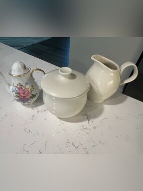 Miniature floral pattern tea pot, and cream creamer & sugar bowl. Pre-owned.